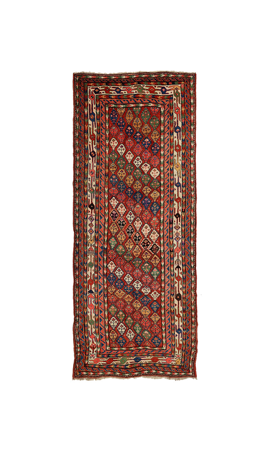 A rectangular vintage Persian runner rug with a complex geometric pattern in red, blue, green, and beige, isolated on a white background.