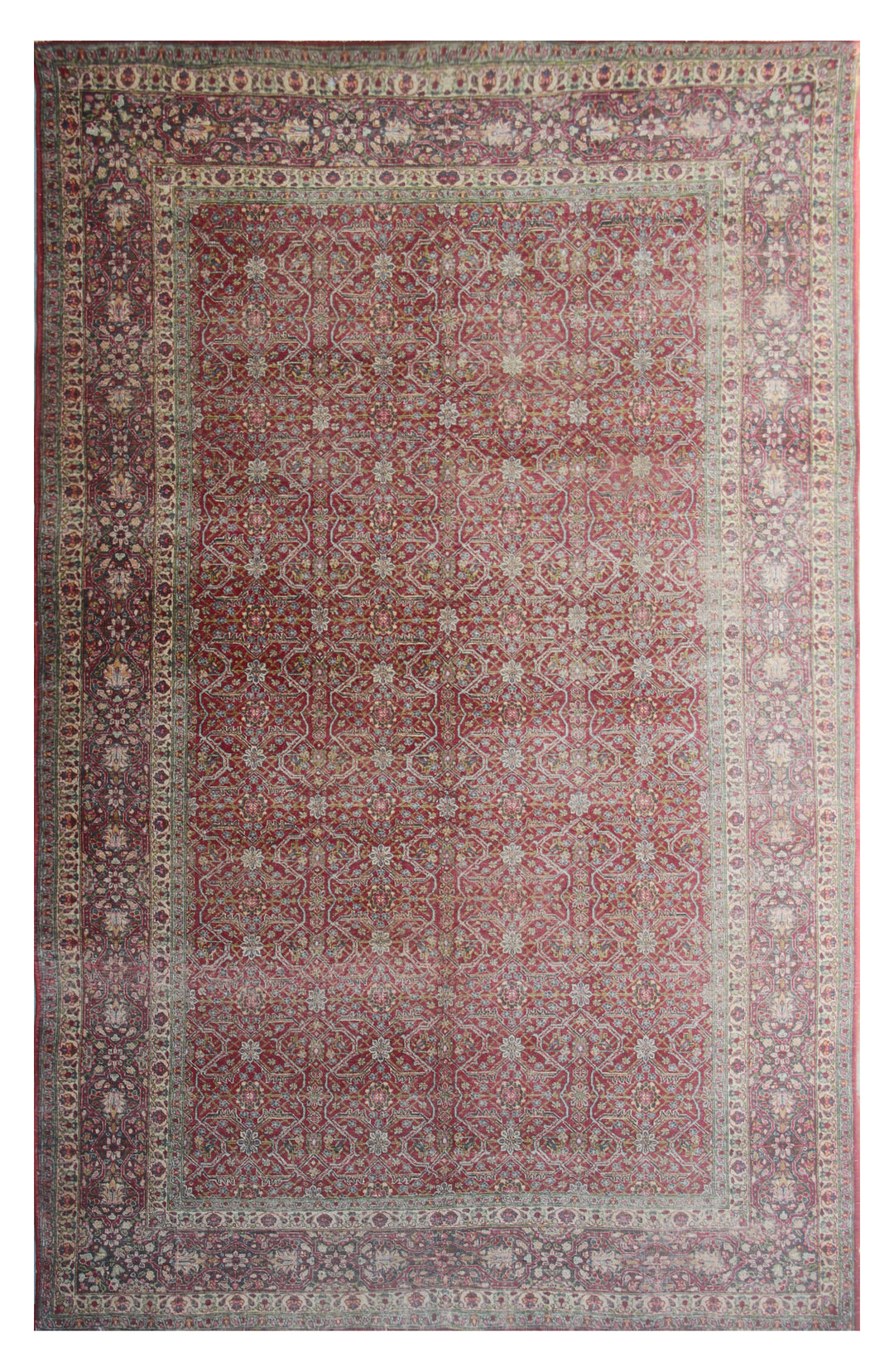 Antique Persian rug with a geometric and floral pattern in red and beige hues.