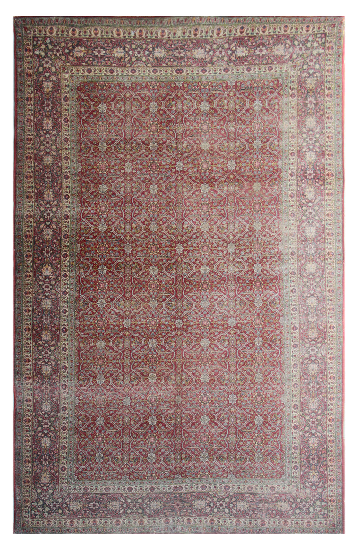 Antique Persian rug with a geometric and floral pattern in red and beige hues.