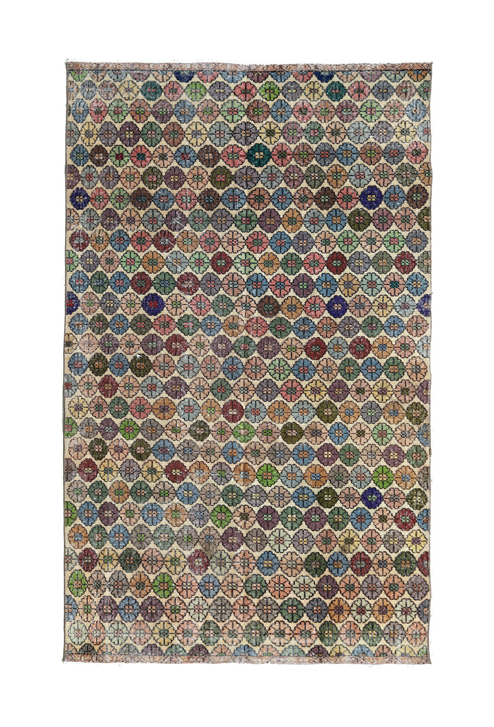 Multicolored geometric patterned rug on a white background