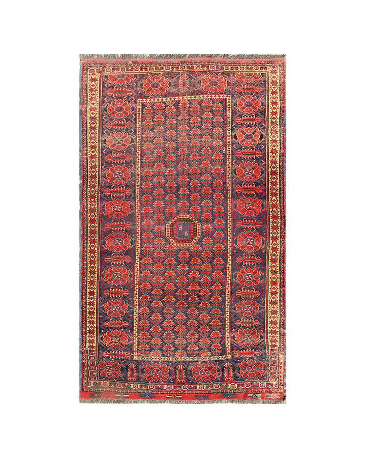 Traditional patterned rug with red and blue colors on a white background