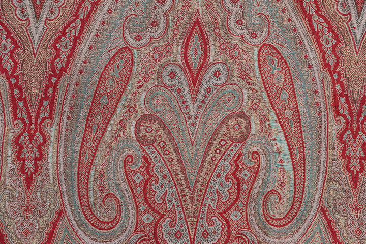 Close-up of a red and beige paisley patterned fabric.