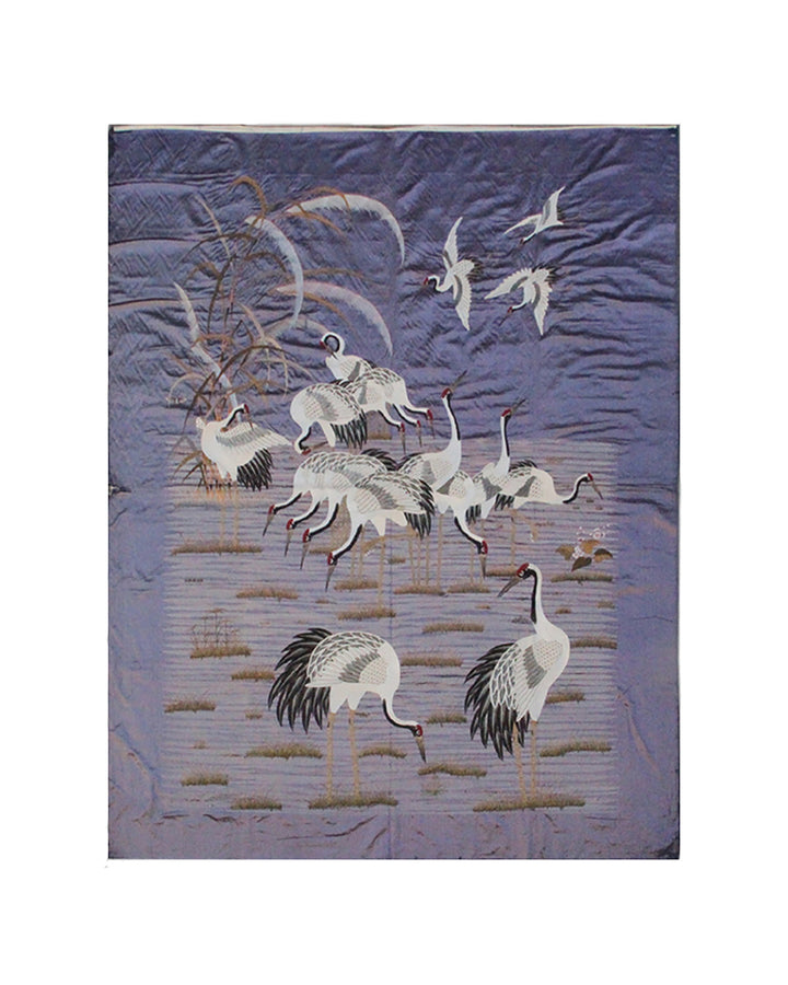 Decorative panel with crane birds design on a textured purple background