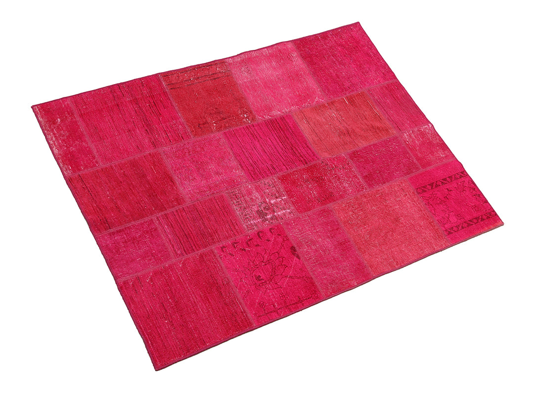 Pink patchwork rug on a white background