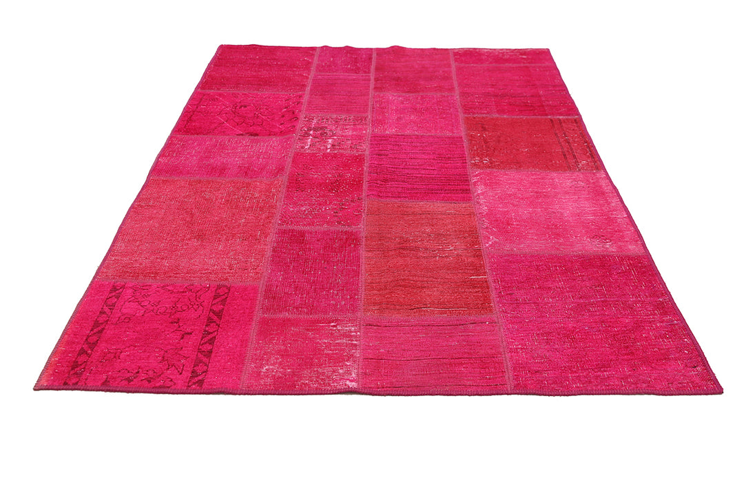 Pink patchwork rug on a white background