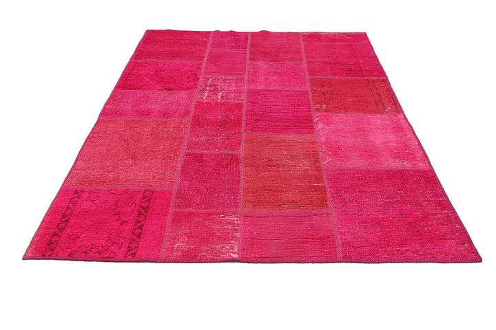 Pink patchwork rug on a white background