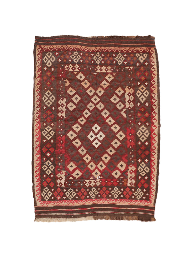 Traditional patterned rug with geometric design on a white background