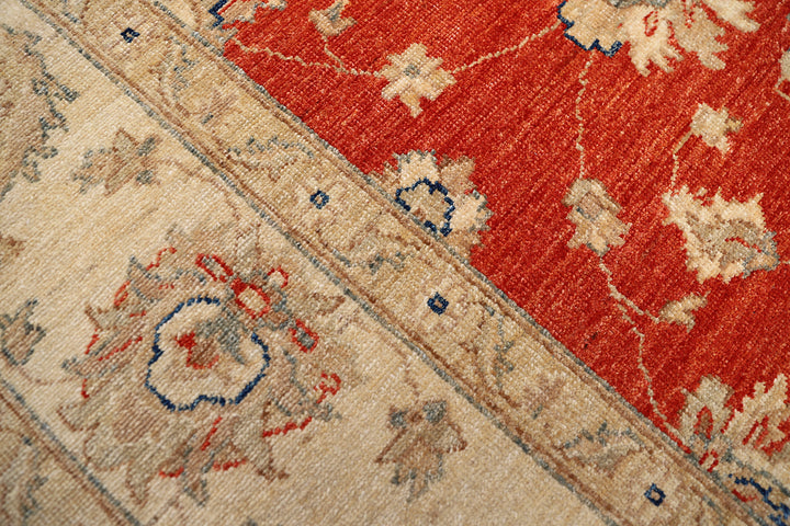 Close-up of a patterned rug with red and beige colors