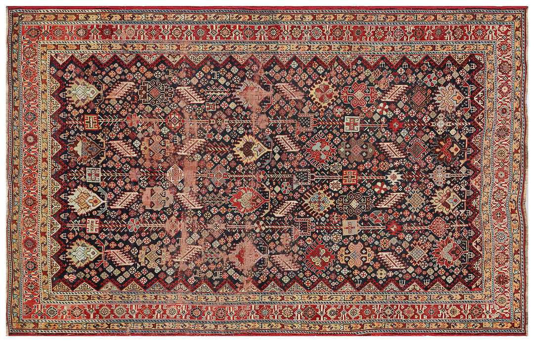Unique 6x9 antique distressed Persian Qashqai tribal rug with navy background from a trusted dealer with over 45 years of experience.