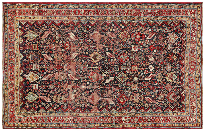 Unique 6x9 antique distressed Persian Qashqai tribal rug with navy background from a trusted dealer with over 45 years of experience.