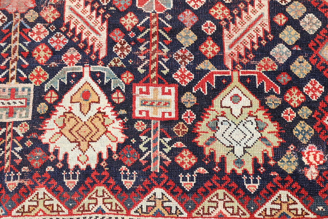Unique 6x9 antique distressed Persian Qashqai tribal rug with navy background from a trusted dealer with over 45 years of experience.