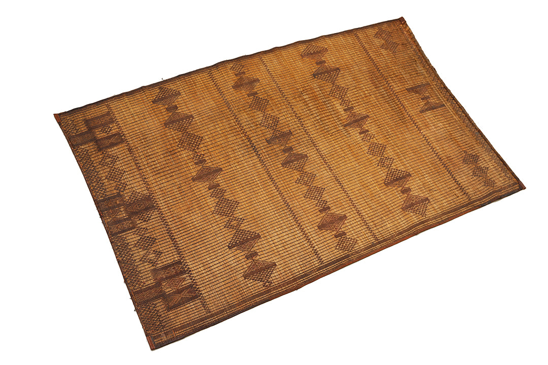 Woven mat with geometric pattern on a white background