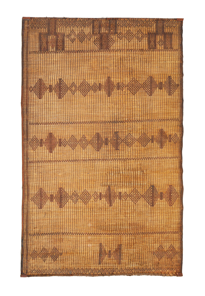 Woven mat with geometric pattern on a plain background