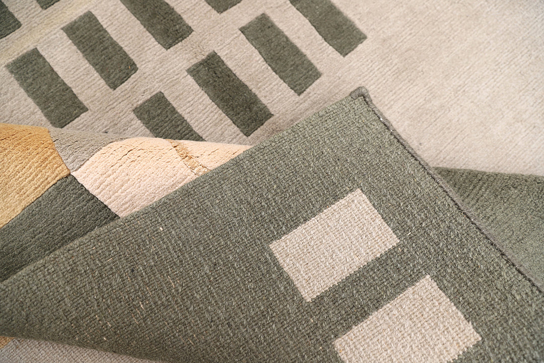 6x9 hand-knotted modern Arts and Crafts wool and silk geometric area rug in green, yellow, ivory, and grey