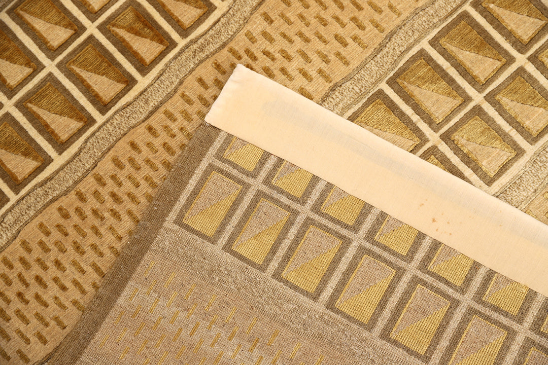 6x9 hand-knotted modern Tibetan wool and silk linear rug in gold and green featuring a plush cut pile with hand-carved geometric lines
