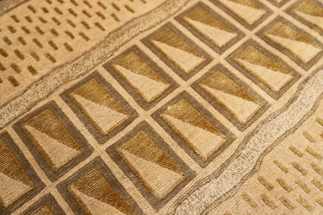 6x9 hand-knotted modern Tibetan wool and silk linear rug in gold and green featuring a plush cut pile with hand-carved geometric lines
