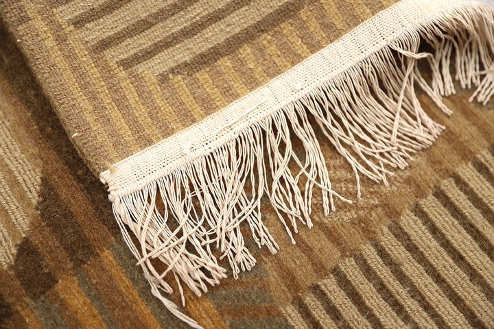 6x9 hand-knotted modern Tibetan wool and silk geometric rug in gold and green featuring a textured cut and loop pile
