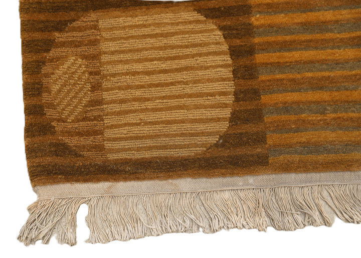 6x9 hand-knotted modern Tibetan wool and silk geometric rug in gold and green featuring a textured cut and loop pile