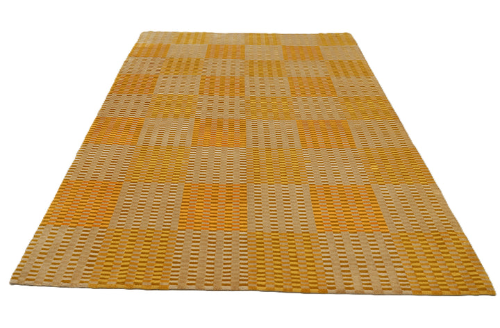 6x9 hand-knotted modern Tibetan wool and silk geometric rug in gold, yellow, orange, and brown with a textured cut and loop pile