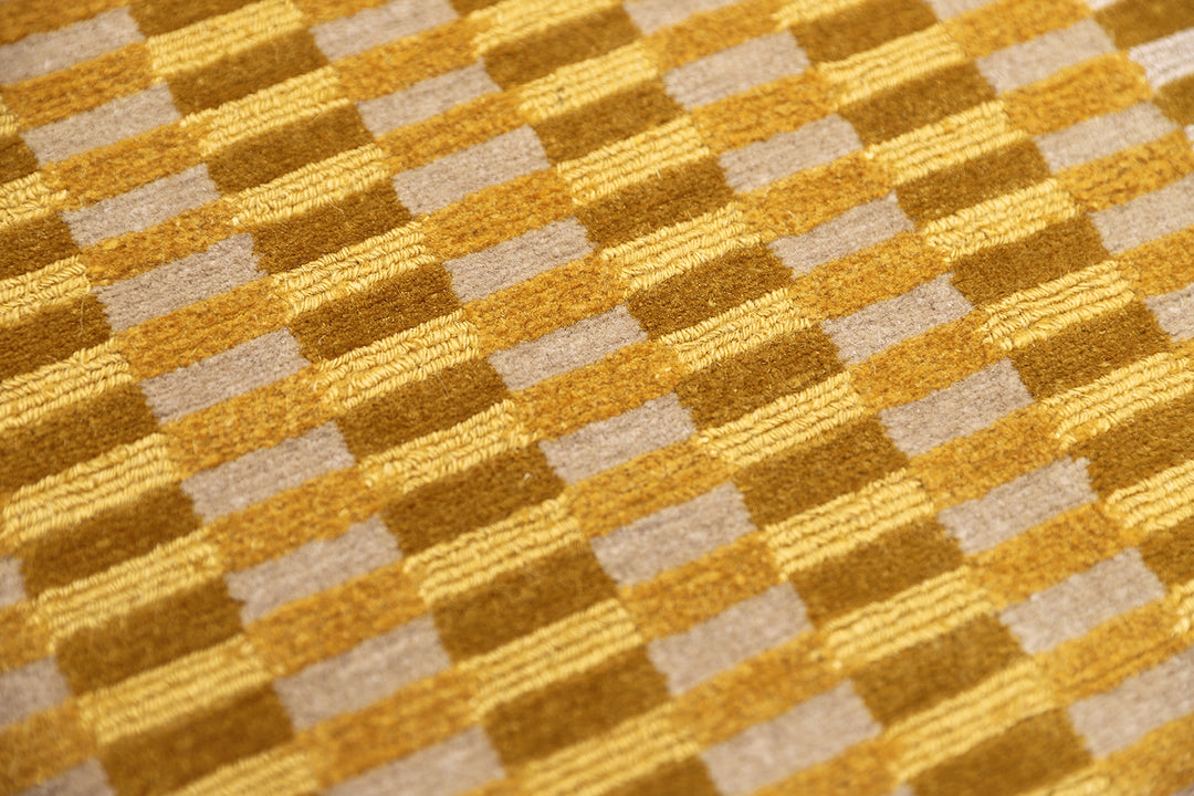6x9 hand-knotted modern Tibetan wool and silk geometric rug in gold, yellow, orange, and brown with a textured cut and loop pile