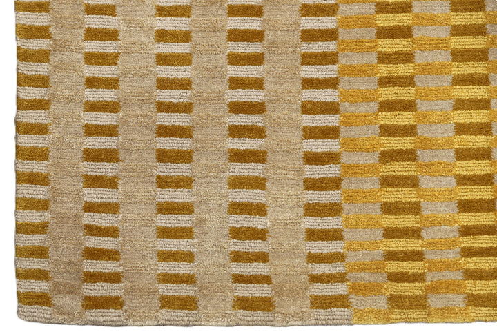 6x9 hand-knotted modern Tibetan wool and silk geometric rug in gold, yellow, orange, and brown with a textured cut and loop pile