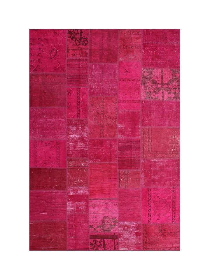 Patchwork rug with pink and red patches on a white background