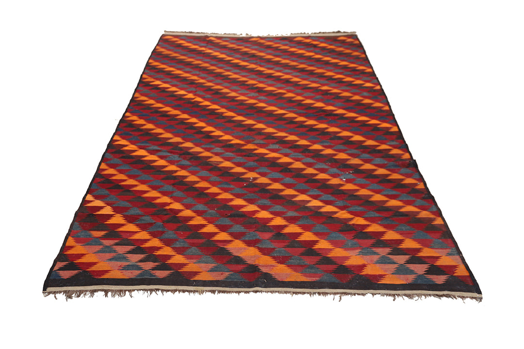 Woven rug with orange and black geometric pattern on a white background