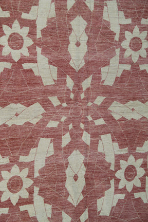 Patterned rug with geometric design on a terracotta red background