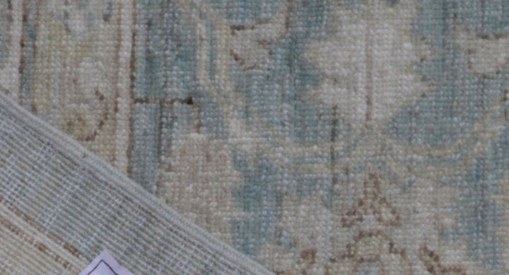Close-up of a textured rug with intricate patterns in neutral colors.