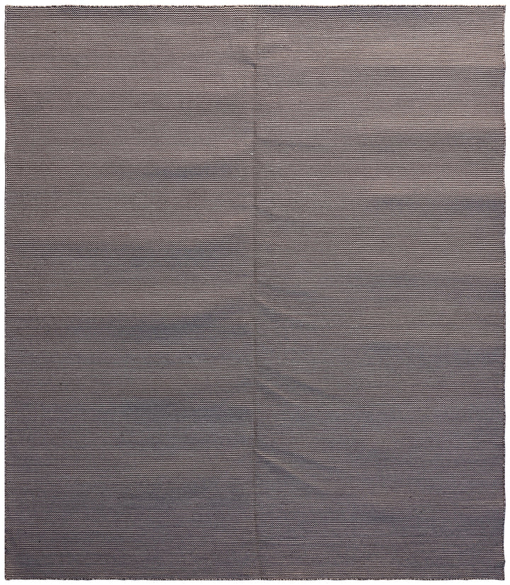 A flatweave rug with a solid gray color and a visible textile structure.