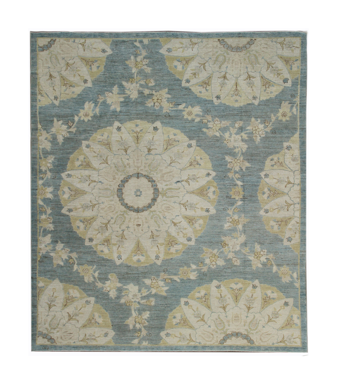 Decorative rug with floral and mandala patterns on a blue background