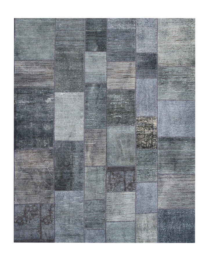 Patchwork rug with various shades of gray on a white background