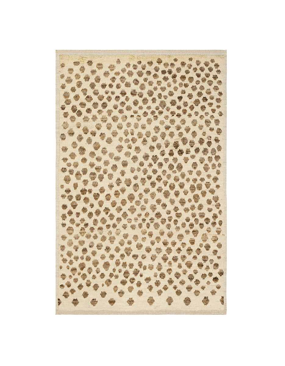 Beige area rug with a subtle pattern on a white background