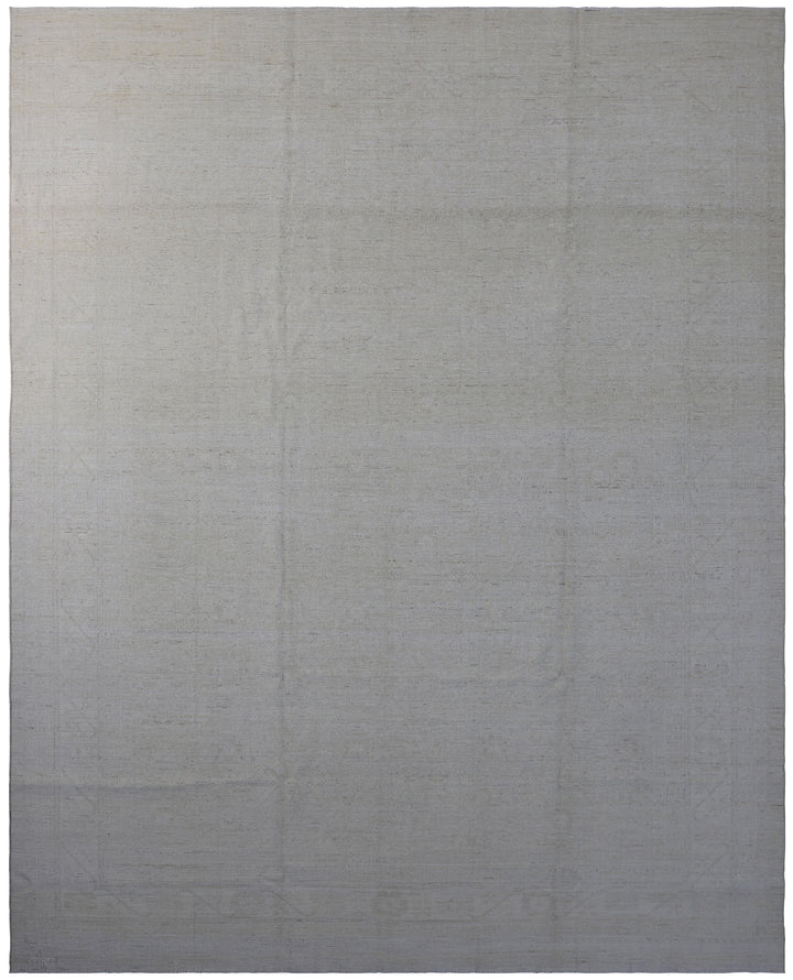 A wool on cotton rug with a geometric design in an ivory color, dimensions 8'10" x 11'7".