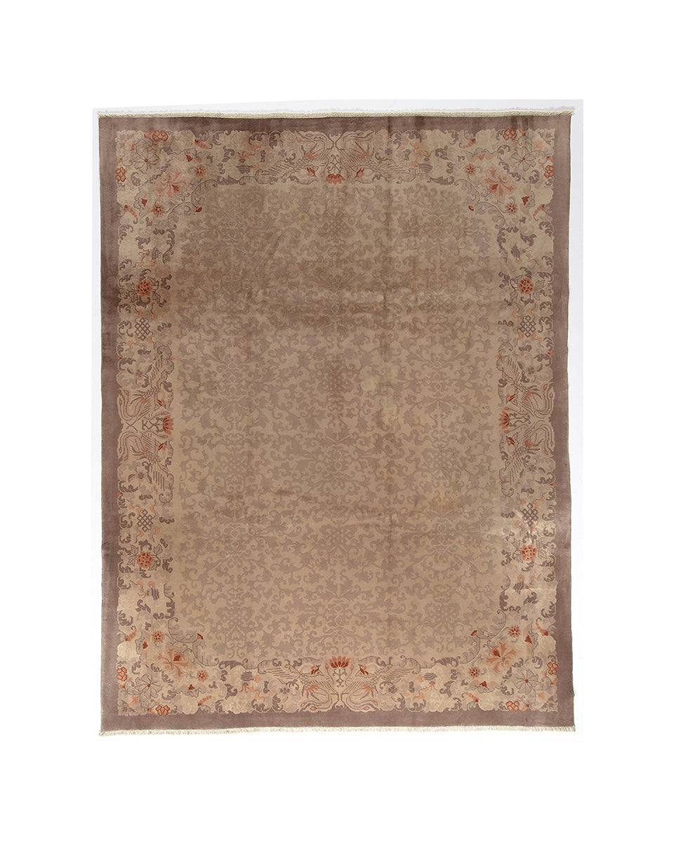Beige area rug with floral border on a white background