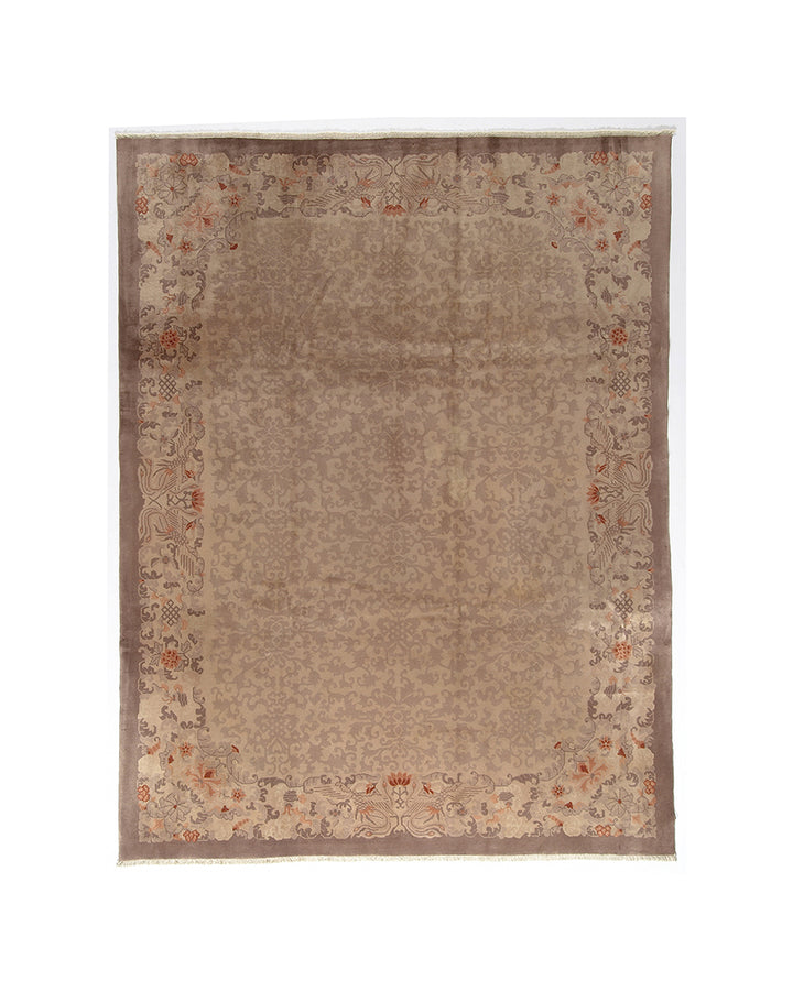 Beige area rug with floral border on a white background