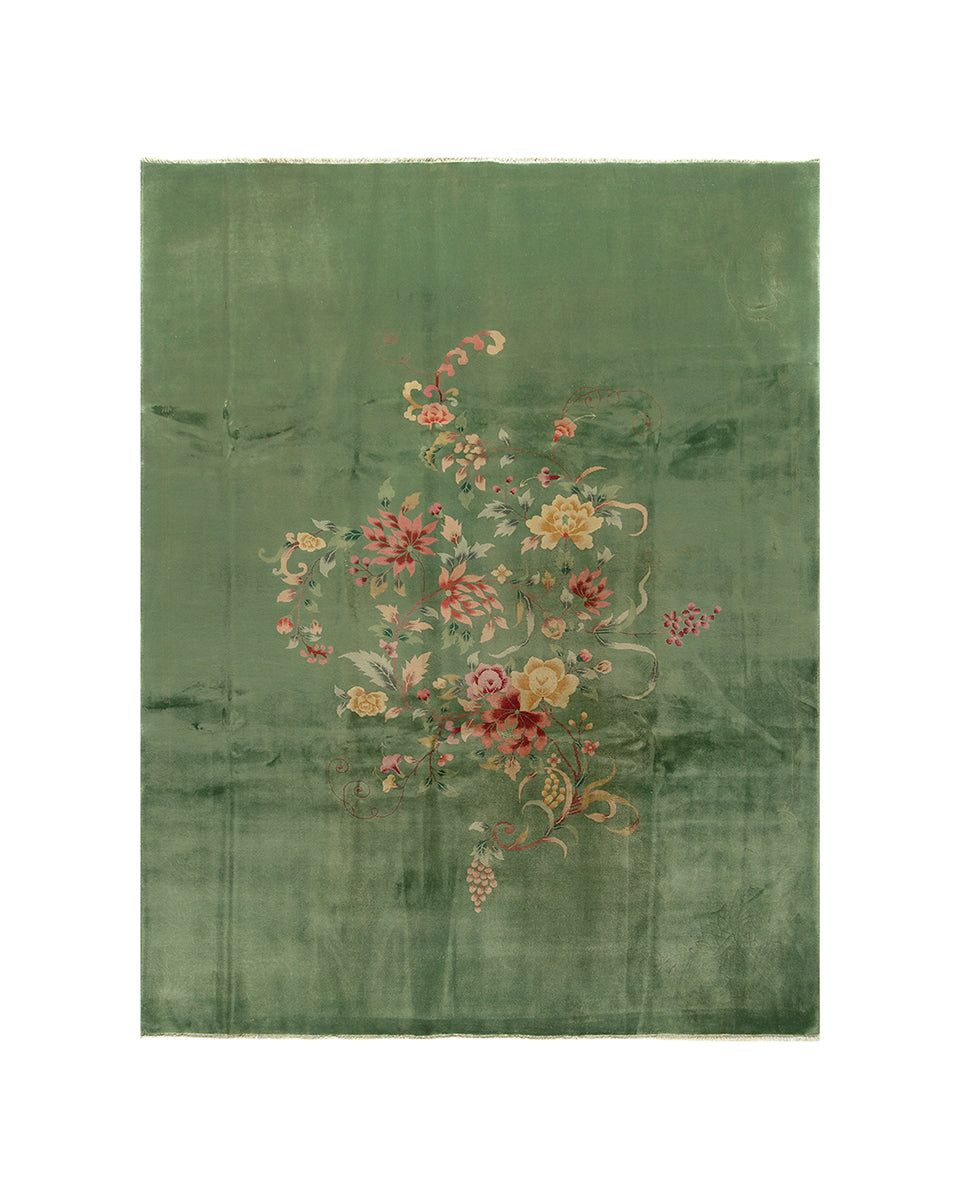Green floral embroidered rug on a white background