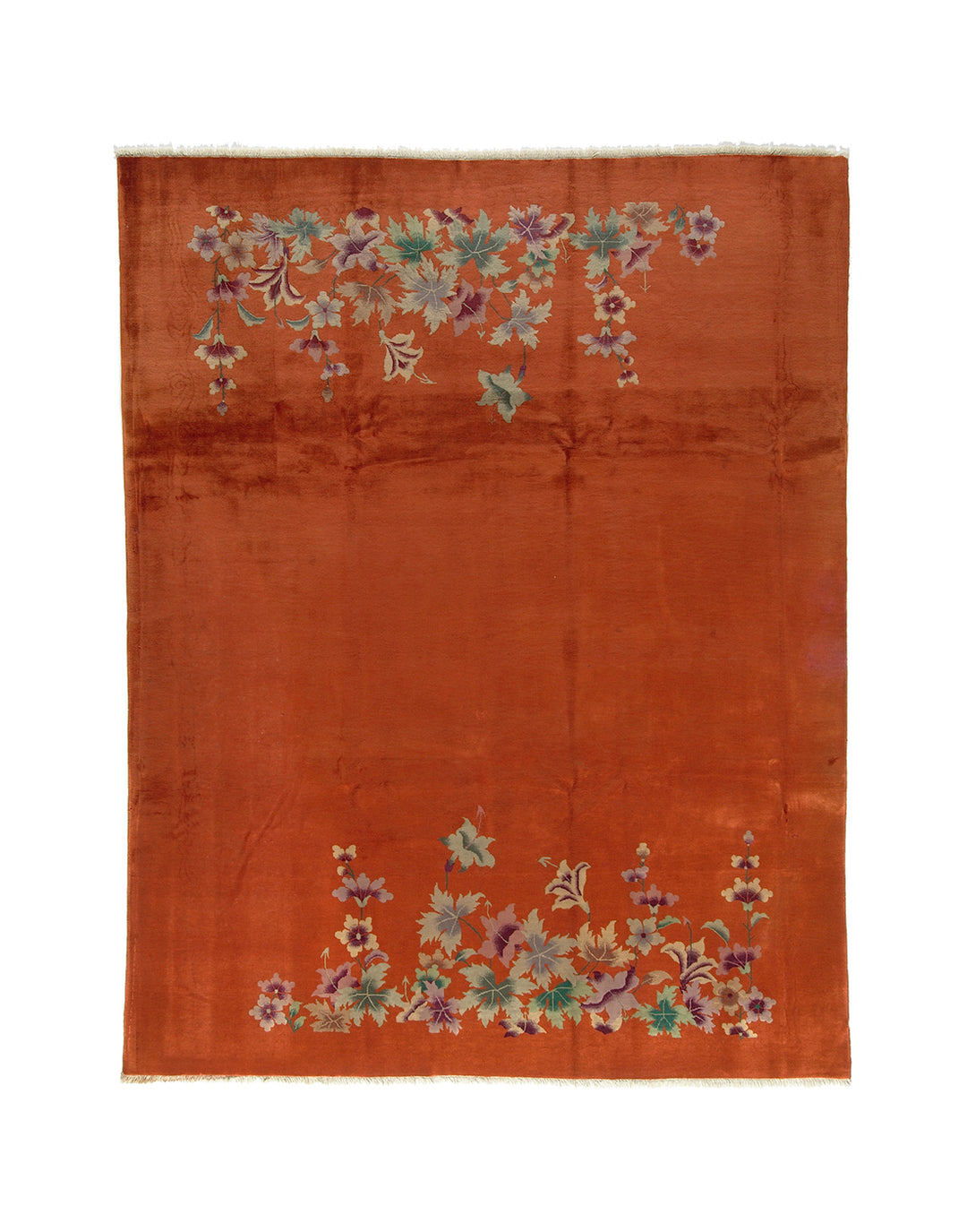 Orange rug with floral patterns on a white background