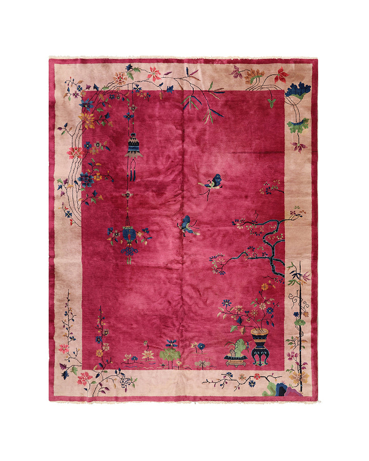 Decorative rug with floral and bird patterns on a red background