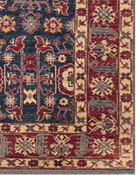 Close-up of a patterned rug with red, blue, and beige colors.