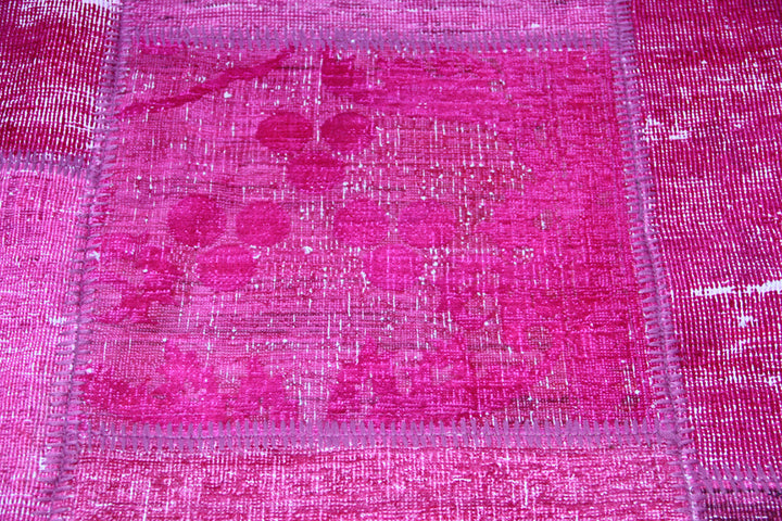 Close-up of a pink patchwork fabric with a grid pattern