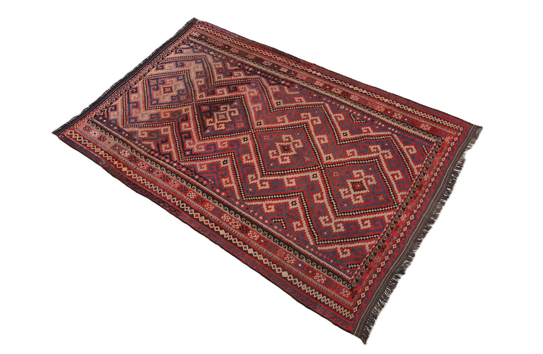 Decorative red and brown patterned rug on a white background