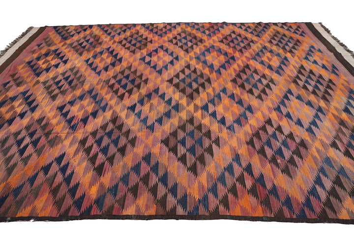Woven rug with geometric pattern on a plain background
