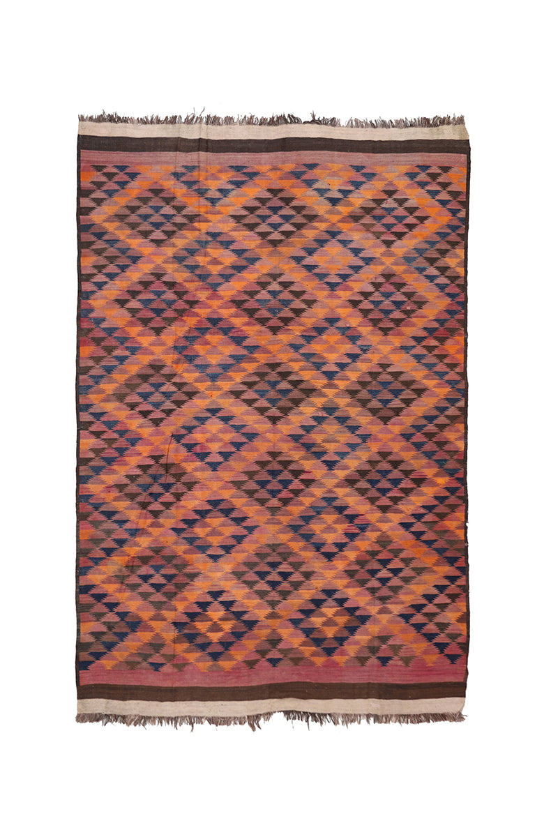 Woven rug with geometric pattern on a white background