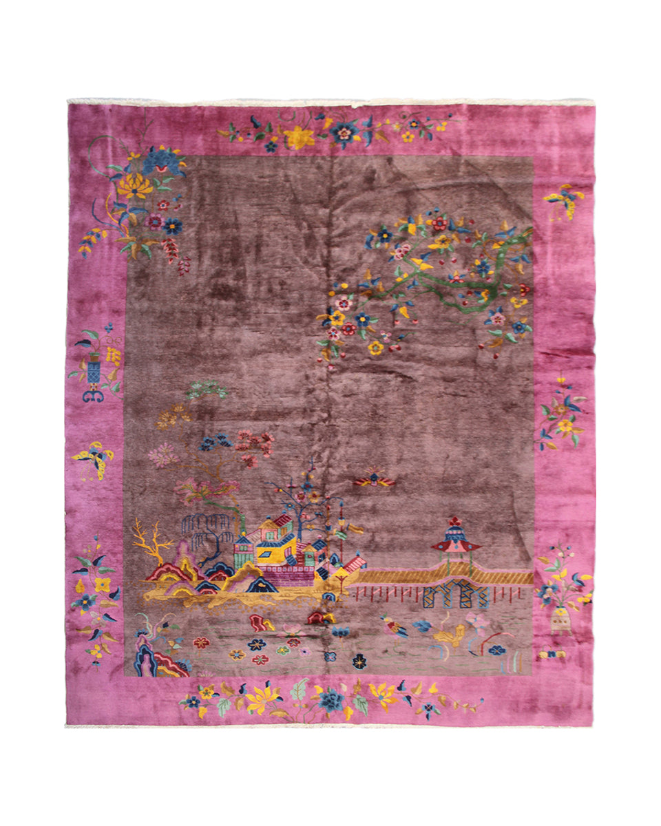 Decorative rug with a pink border and colorful patterns on a white background