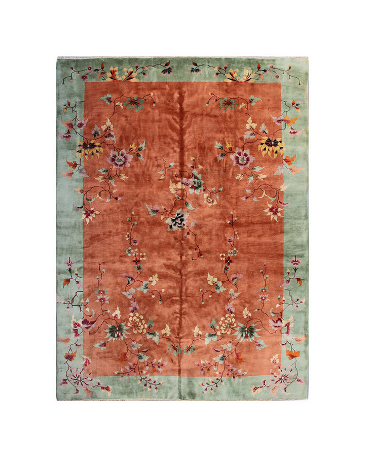 Floral patterned rug with a gradient from green to orange