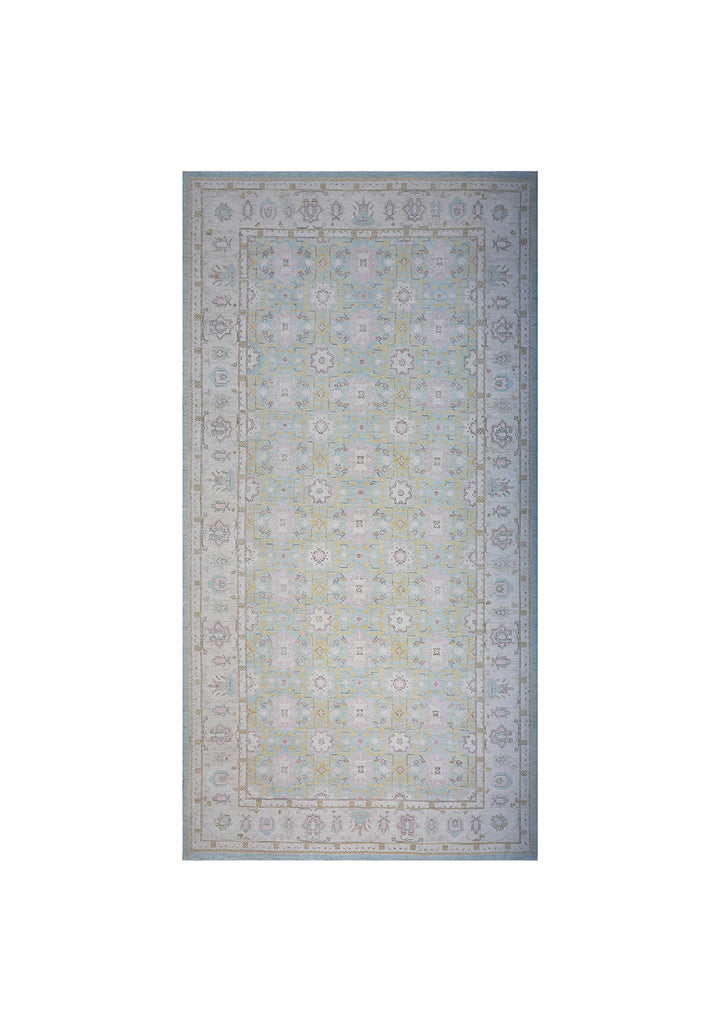 Full-length view of a massive 9x17 authentic hand-knotted wool rug from the Ariana Traditional Collection, showcasing the intricate Agra 505 pattern in deep blue, ivory, and soft pink.