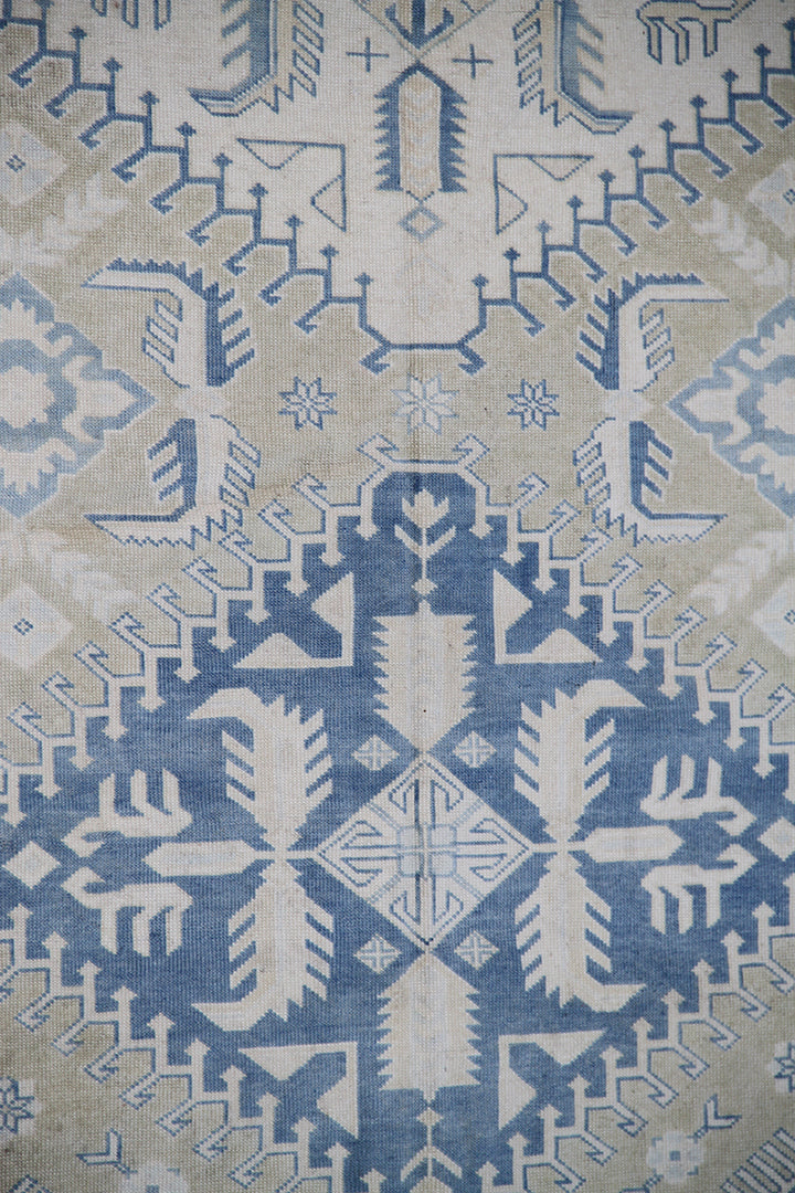 Close-up of a patterned rug with blue and beige colors