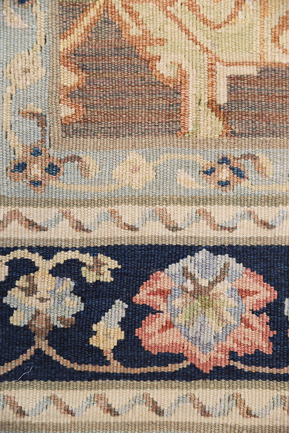 Close-up of a patterned rug with intricate designs and colors.