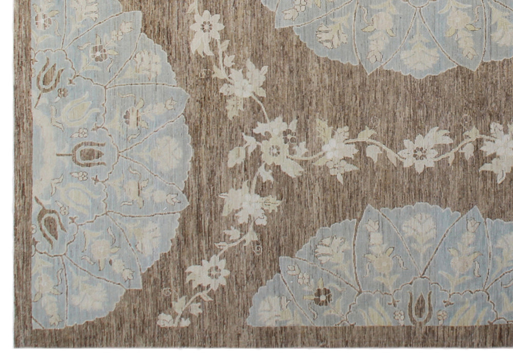 Top-down view of a luxury 9x12 Ariana rug with ivory field, blue and brown Ottoman palmettes, and short wool pile.